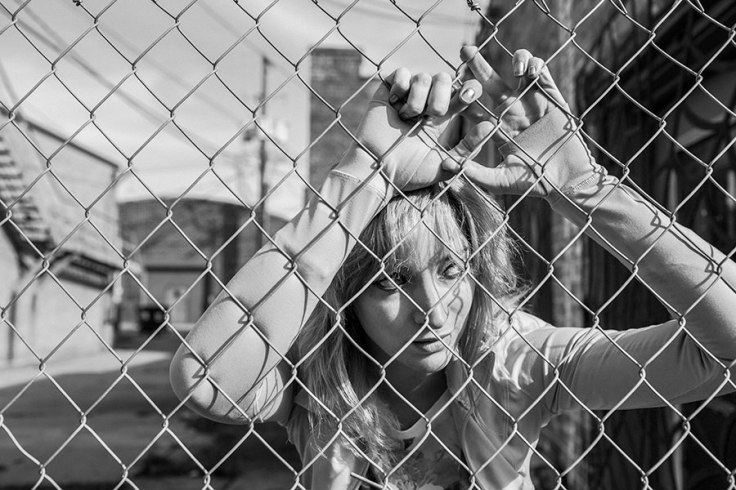 Girl Behind Fence
